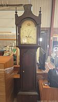 full view of grandfather clock showing bonnet, dial, trunk and base
