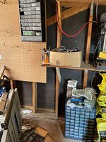 Workshop wall showing wall-mounted parts organizer and surrounding items