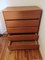 Front view showing five drawers, two opened