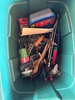 Overview of tote with mixed hand tools and accessories