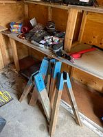 overview of lot showing sawhorse legs and bench with hardware