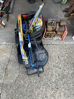 Overview of lot showing creeper seat, oil drain pan, packaged wiper blades, brush, assorted small tools
