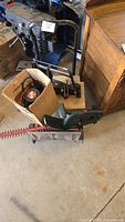 Overview of lot showing tile cutter, router in box, hedge trimmer blade attachment