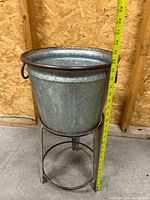Planter on stand with tape showing approximately 24 in. height
