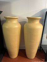 Front view of both large yellow terracotta urns