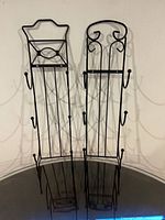 Front view of both wrought iron towel racks showing full shape and height