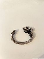 Single napkin ring close-up showing twig band and poinsettia leaves