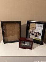 Overview of three shadow boxes on white surface