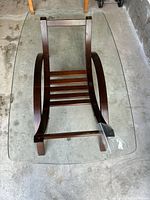 Table upside down highlighting full glass top and wooden base