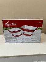 Front of Lagostina box showing four red and white stoneware baking dishes