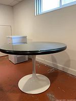 Full view of table showing glass-covered top and pedestal base