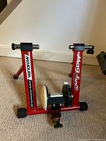 Overall view of red Minoura Mag 500 trainer frame standing upright