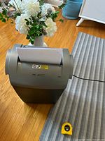 Front angled view showing overall shredder design and size reference with tape measure