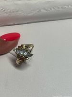 Ring angled view showing aquamarine cluster and gold band