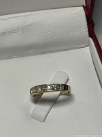 Ring in box showing full band and stones