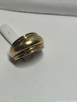 Front view of 10K yellow gold domed triple-ridge band ring