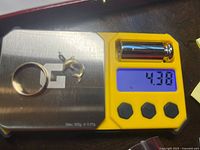 Ring and charm on scale showing 4.38 g