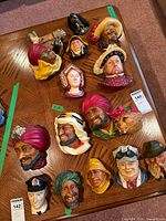 All 14 Bossons chalkware plaques on table