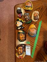 All eight chalkware plaques on table for group overview