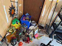 Corner of garage with mixed garden items