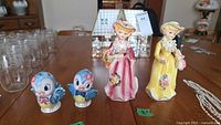 Full lot showing two lady figurines and two blue bird shakers