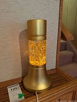 Lamp illuminated displaying gold glitter