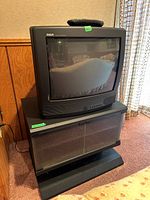 RCA CRT TV on stand showing overall lot