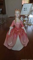 Front view of Royal Doulton Debbie figurine showing full gown and facial features