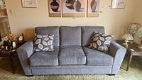 Front view of grey sofa with two cushions