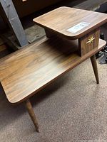 Full view of two-tier table showing legs and surfaces