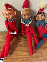 Three vintage knee-hugger elves seated together