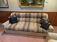 Front view of couch showing striped upholstery and four cushions