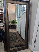 Framed wall mirror leaning against wall