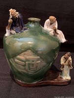 Front view showing vase, relief motif, three attached Mudman figures