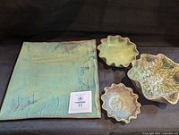 Top view of seafoam teal square tray with three ruffled bowls
