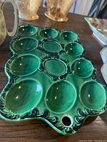 overhead view of green glazed ceramic deviled egg tray