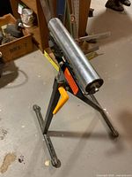 Overall view of roller stand showing frame, roller and handle