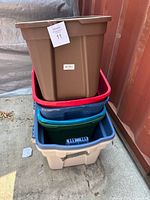 Stack of brown, red, blue, green and light blue totes