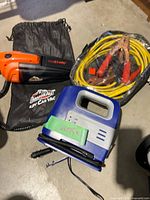 Vacuum, inflator and jumper cables grouped together