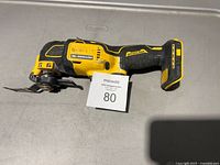 Left side view of DeWalt 20V MAX brushless oscillating tool with attached blade