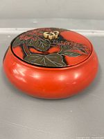 Front angle of red lacquer trinket box with lid on