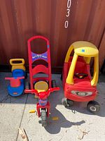 Three ride-on toys side by side on pavement