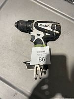 Left side view showing Makita branding, torque selector and belt clip