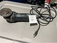 Full view of angle grinder with cord and disc