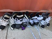 Five pairs of skates front view showing laces and toe condition