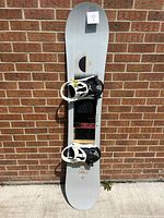 Full view of snowboard with bindings attached