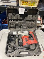 Drill in open hard case with bits visible