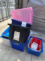 Stack of assorted plastic totes and bins showing colours and sizes