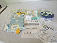 All items laid out: centerpiece, stand-ups, plates, napkins, confetti, game sheets, table card