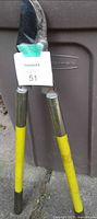 Full view of 30 in. bypass garden loppers leaning against bin, showing yellow handles and blade